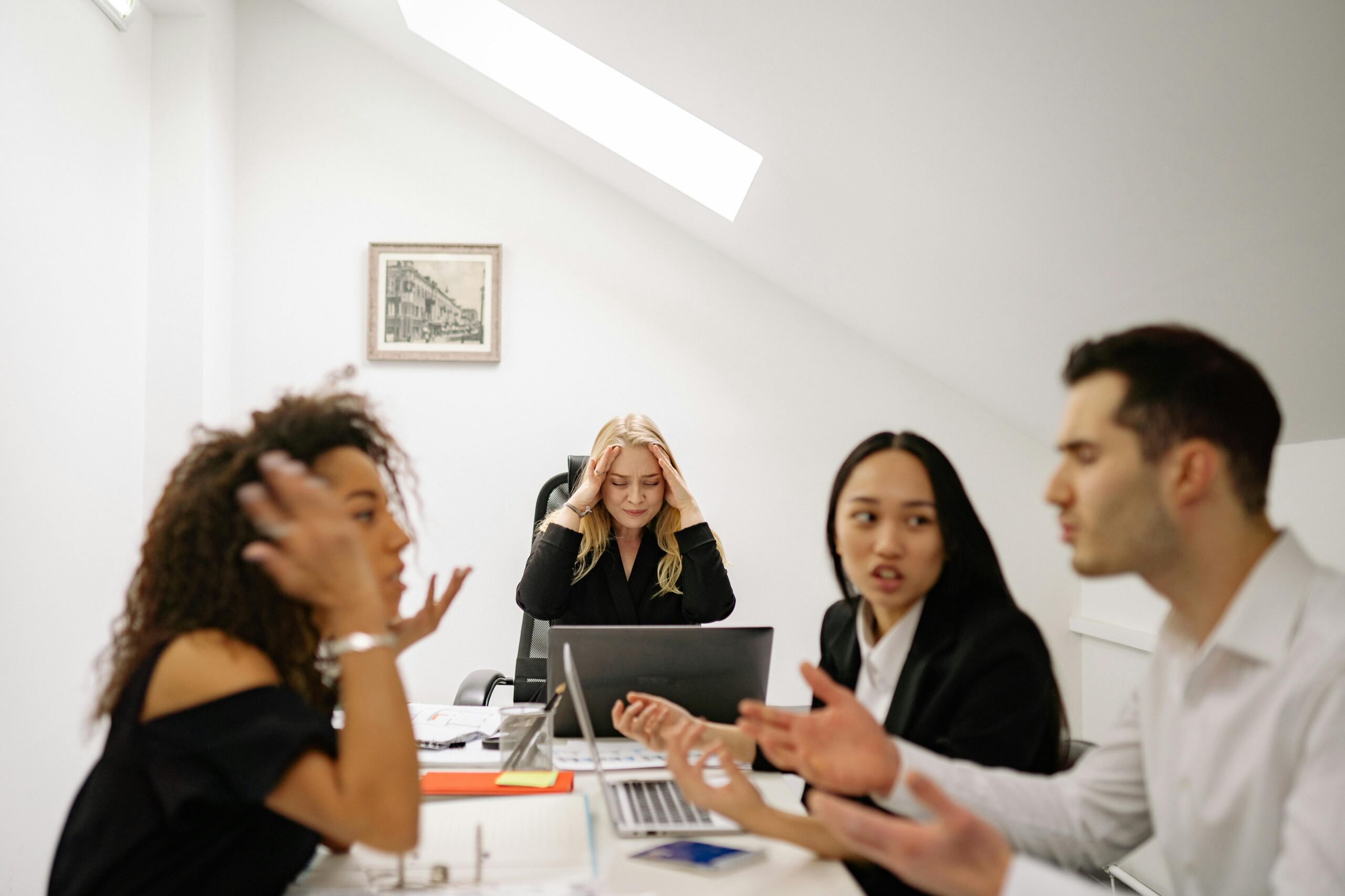 Colleagues in a tense discussion at a workplace meeting